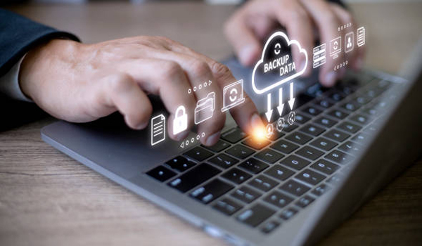 Businessman using a computer to backup storage data Internet technology concept for backup online documentation database and digital file storage system or software,file access, doc sharing.